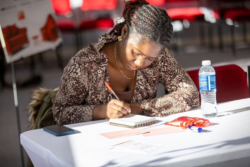 Business support for women Scotland a woman writing at an Adelphe Connect event