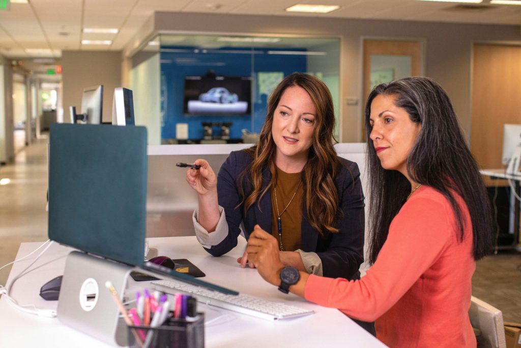 Women’s wellbeing support Scotland two women in an office having a discussion