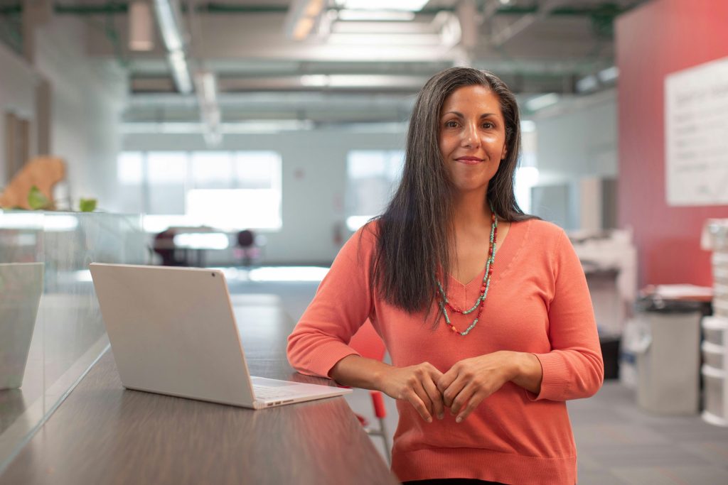 menopause support in scotland a confident woman at her desk at work