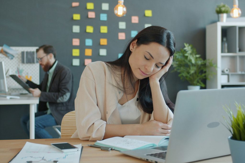 menopause support in scotland a women falling asleep at her desk